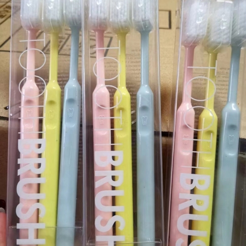 three boxed toothbrushes
