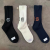 Socks men's and women's same towel bottom mid-tube socks solid color jacquard letter casual socks Japanese cotton sports